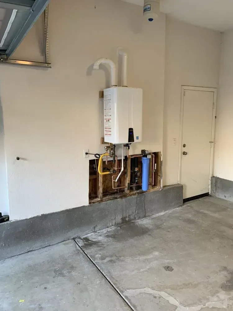 Wall-mounted tankless water heater and supply connections